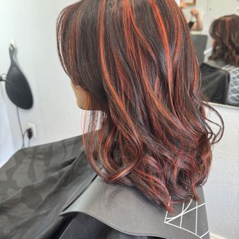 Red copper highlights on dark hair
